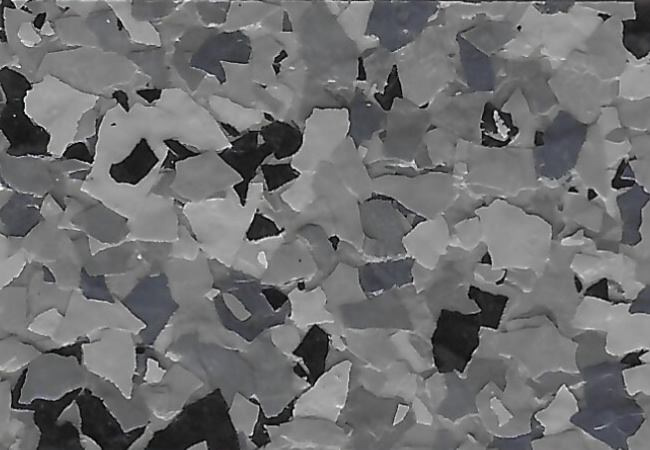 Close-up of a grayscale terrazzo surface with irregular light- and dark-gray chips scattered throughout.
