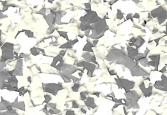 Close-up of a terrazzo floor with white and gray stone chips scattered in a light matrix.