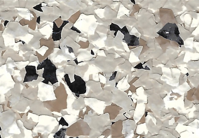 Close-up of terrazzo-like flooring with white, beige, and black stone chips scattered in a speckled pattern