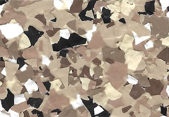 Close-up of terrazzo surface with beige, tan, white, and black chips scattered throughout.