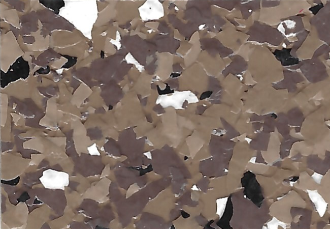 Close-up of a speckled terrazzo surface with irregular brown, tan, black, and white chips.