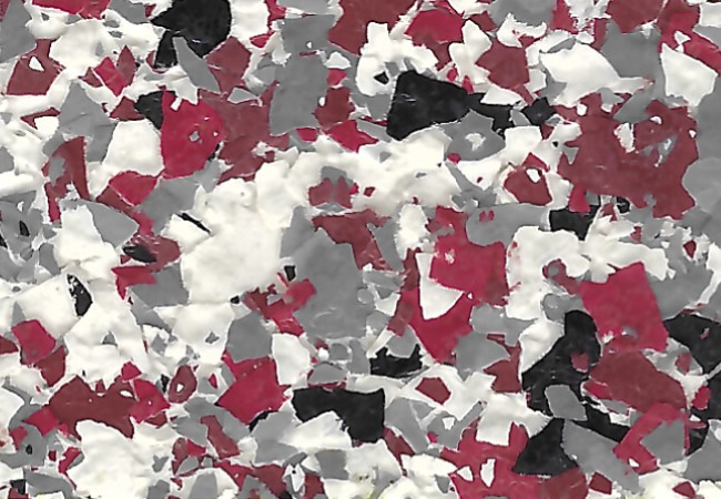 Abstract torn-paper collage with red, white, gray, and black pieces gives a confetti-like texture.