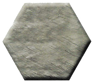Hexagonal metal plate with a brushed gray finish viewed from above