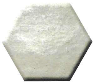 White hexagonal tile fragment with a rough, textured surface photographed top-down